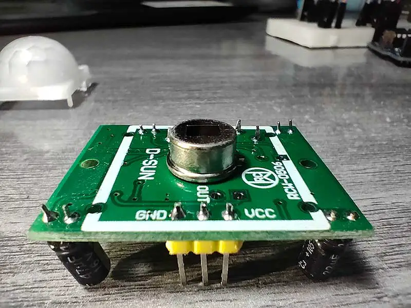You can clearly see the pin labels (GND, OUT, VCC) of this HC-SR501 PIR module by D-SUN